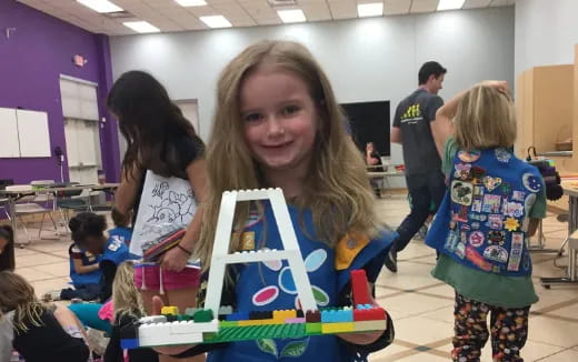 a girl holding a toy