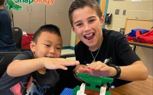 a boy and a boy playing with a toy