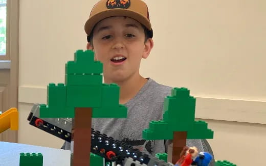 a boy playing with a toy train