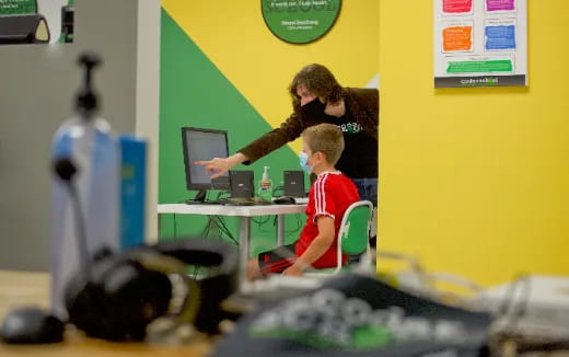 a man and a boy using computers