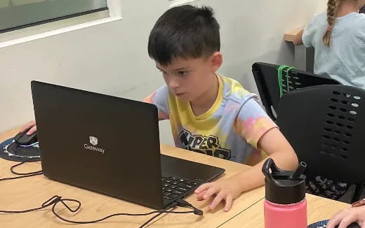 a boy using a laptop