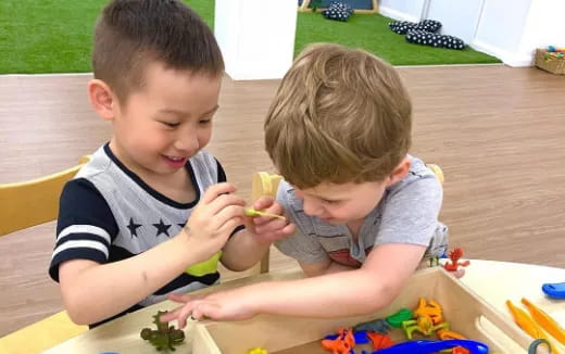 two boys sitting at a table