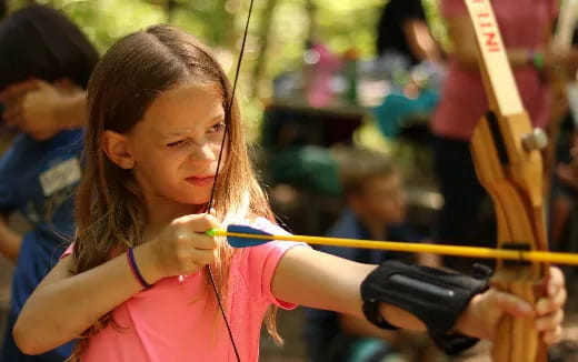 a girl holding a toy gun