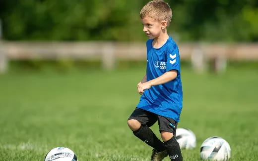 a young boy playing football