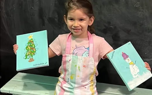 a young girl holding books