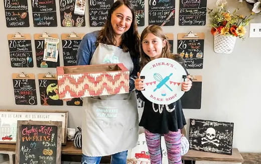 a couple of girls holding up signs