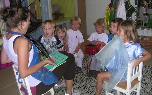 a group of children sitting in chairs