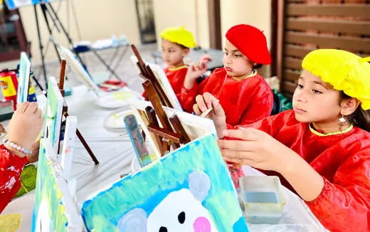 a group of children painting