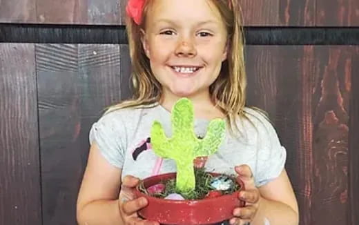 a girl holding a plant