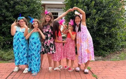a group of girls wearing party hats