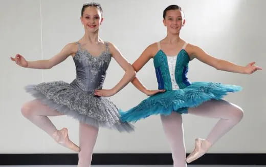 two women dancing in dresses