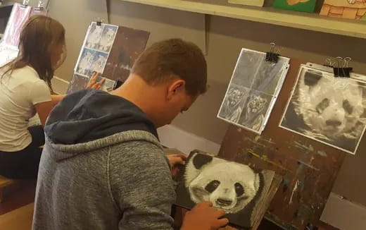 a man and a woman looking at pictures on a wall