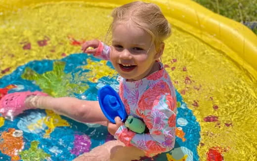a baby in a yellow and blue hammock