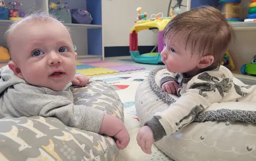 a baby lying on a blanket