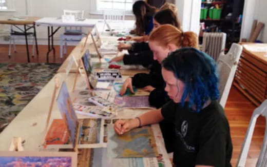 a group of people painting