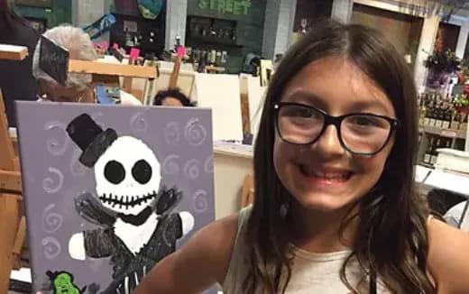 a person smiling with a stuffed animal