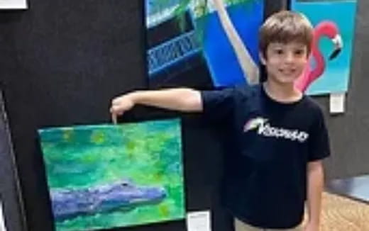 a boy holding a painting