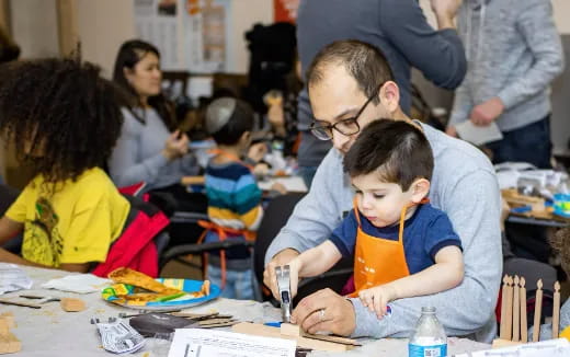 a person and a boy sitting at a table