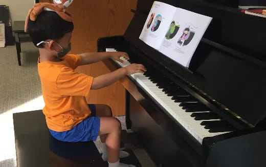 a boy playing a piano