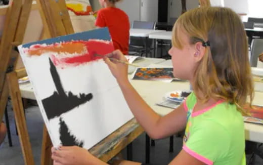 a girl painting a picture