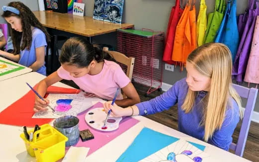 a few young girls painting