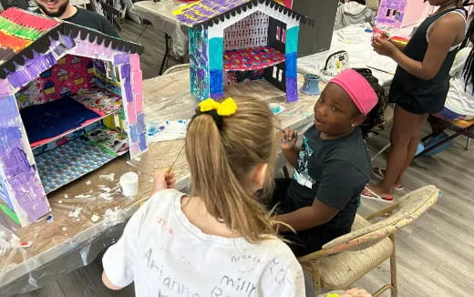 a couple of children painting