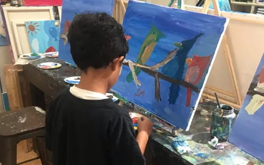 a boy painting a picture