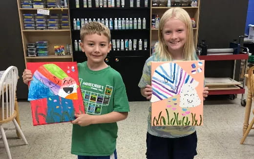 a couple of children holding kites