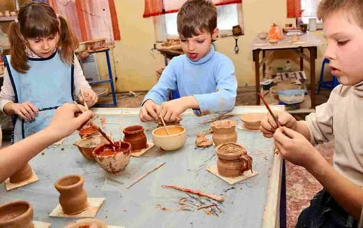 a group of children painting