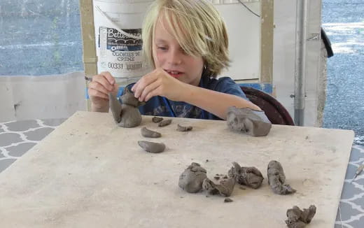 a child playing with shells
