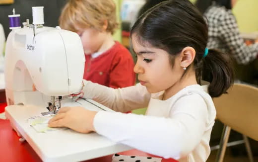 a young girl using a microscope