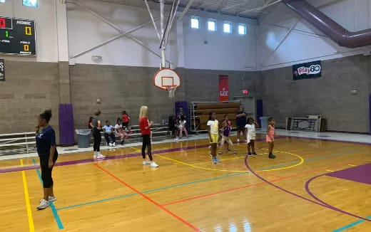 a group of people playing basketball