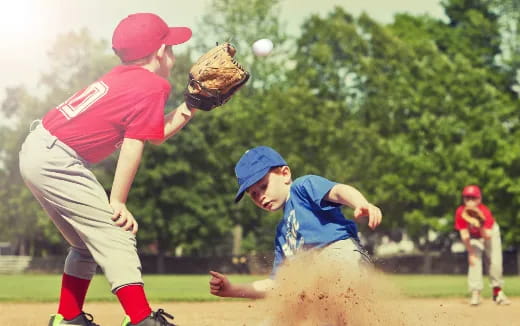 a kid catching a baseball