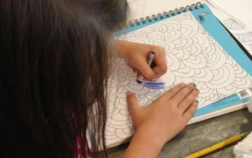 a person drawing on a map