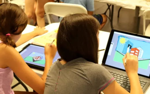 a few children using laptops