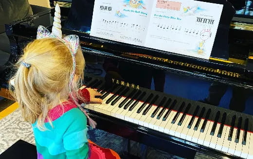 a girl playing a piano