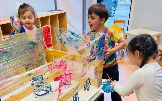 a group of children painting