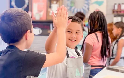 a boy raising his hand