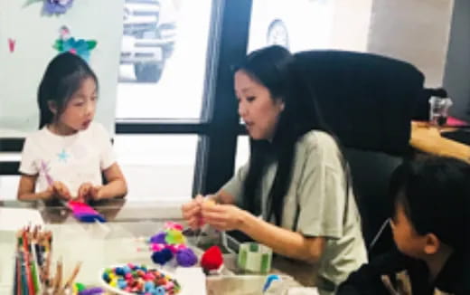 a person and a child sitting at a table