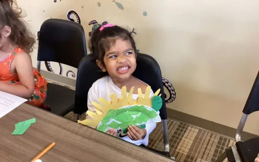 a girl sitting at a table