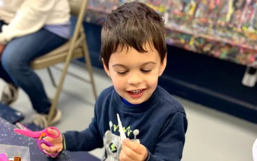 a boy holding a toy