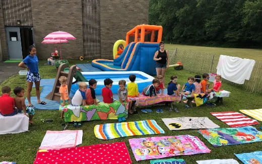 a group of people sitting on the grass