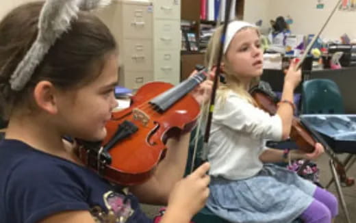 a girl playing a violin