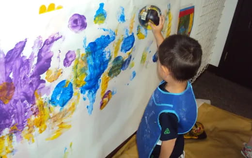 a child painting on a wall