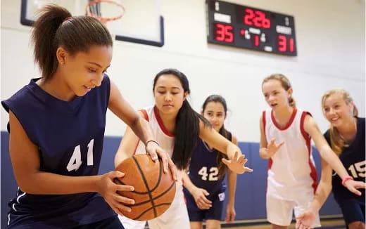 a group of women playing basketball