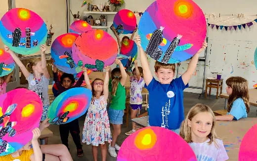 a group of children holding balloons