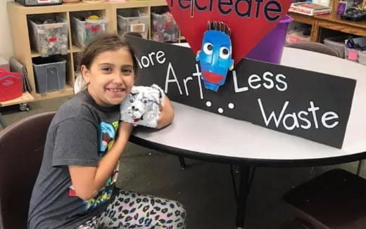 a girl holding a toy