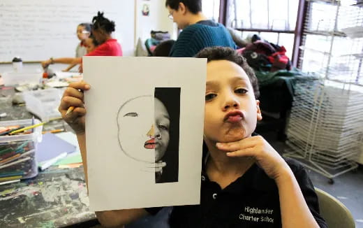 a boy holding a drawing