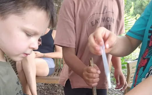 a boy holding a lizard