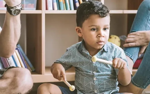 a child holding a pencil